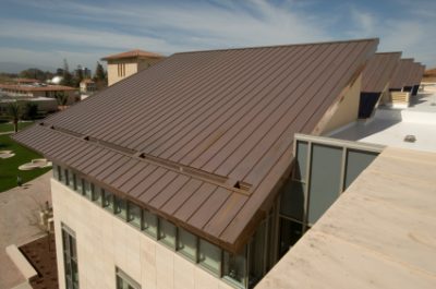 Brown metal roof on a modern tan building