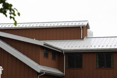 Light gray metal roof on a brown home